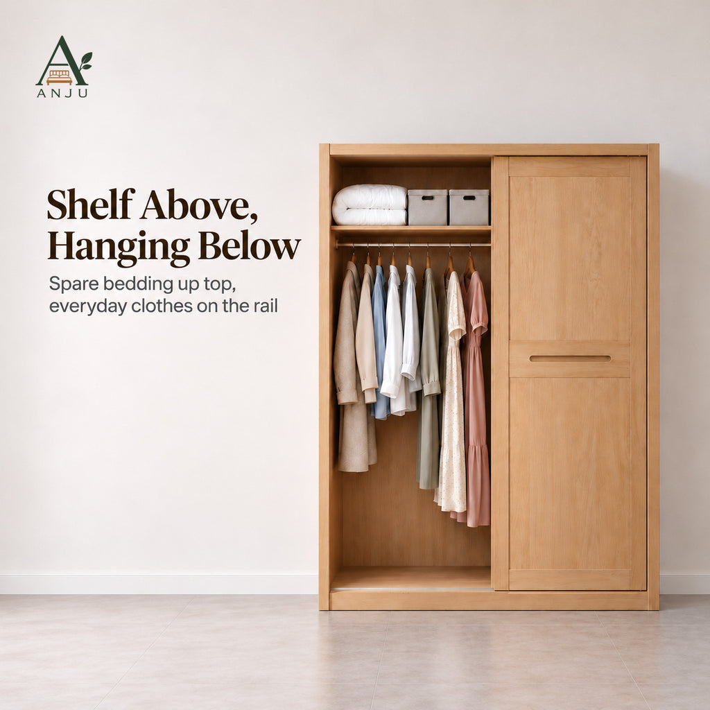 Natural sliding wardrobe with one door slid across, showing a top shelf with bedding and a rail of hanging clothes