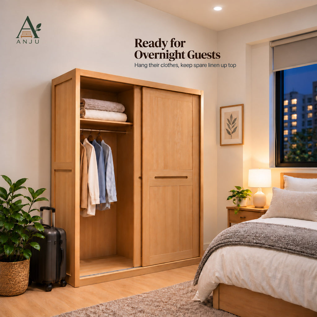Natural sliding wardrobe with the door slid right, showing folded linen on a shelf and shirts on a rail in a bedroom