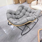 Gray ANJU padded rocking chair with thick tufted cushion and black metal rocking frame
