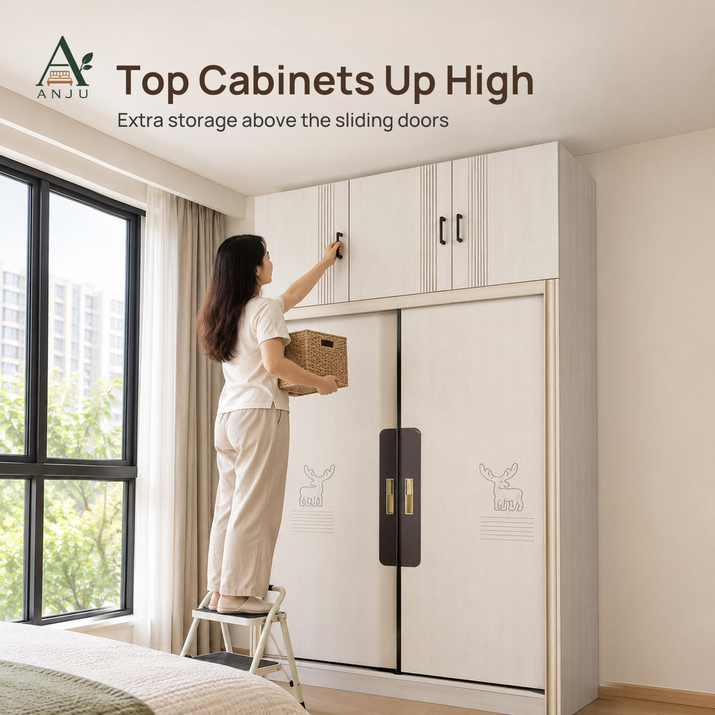 Woman on a step stool reaching the top cabinet of a white 2-door sliding wardrobe, holding a woven basket