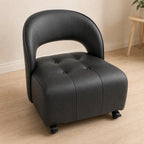 ANJU low lounge chair with wheels and C-shaped back in black, 45-degree view